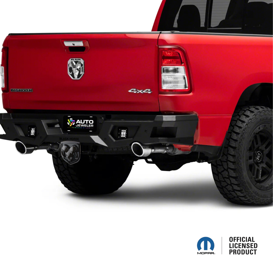 Black RAM illuminated hitch cover installed on truck rear angle view
