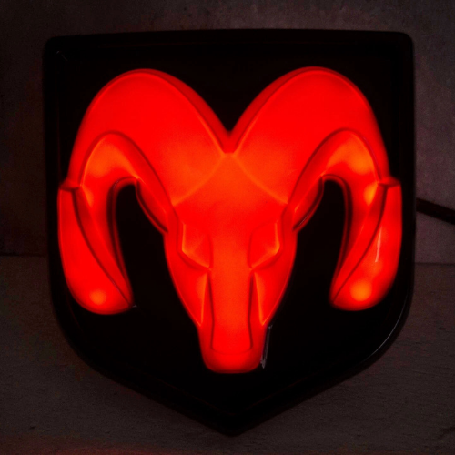 Close-up of RAM lighted tailgate emblem glowing red with COB LED illumination