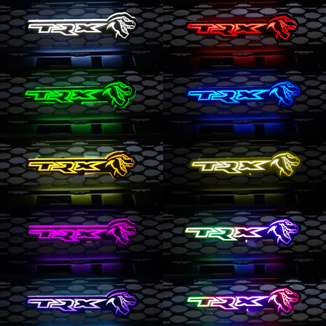 TRX LED grille emblem color options in white, red, green, blue, yellow, purple, and RGBW on a dark honeycomb background.