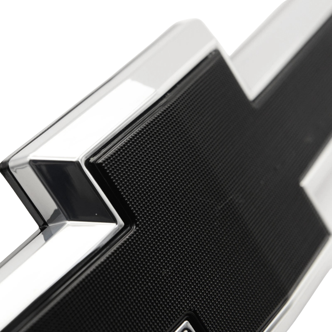 Close-up detail of chrome and black textured LED bowtie grille emblem for 2016–2018 Chevy Silverado 1500