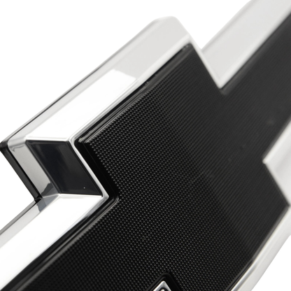 Close-up detail of chrome and black textured LED bowtie grille emblem for 2016–2018 Chevy Silverado 1500