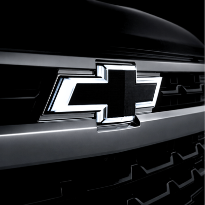 Chevrolet logo on a car grille with a dark background