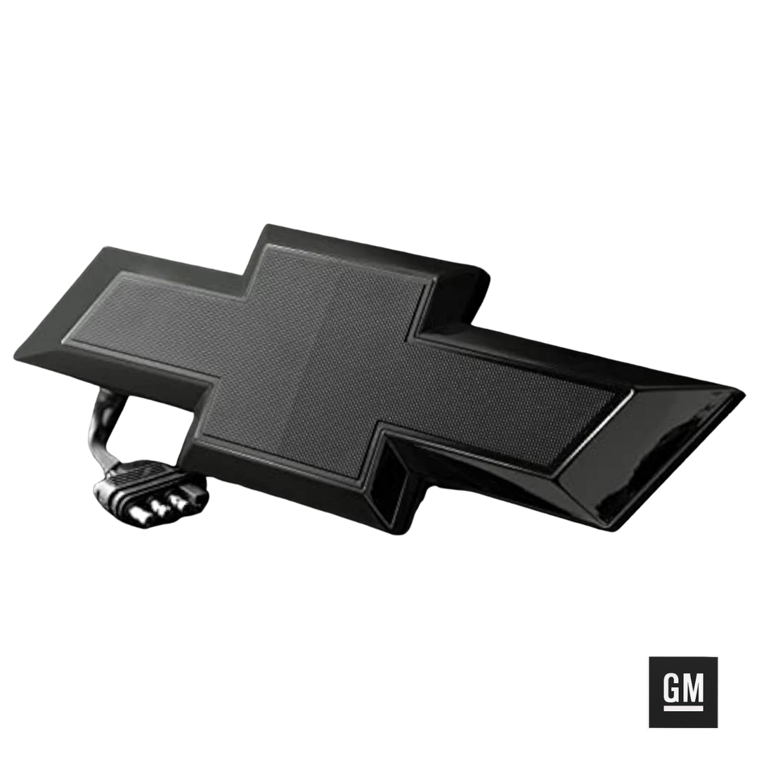 Black tailgate bowtie emblem powered off on white background with 4-pin trailer plug.