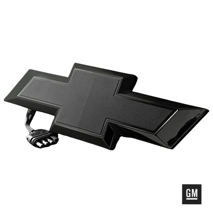 Black tailgate bowtie emblem powered off on white background with 4-pin trailer plug.