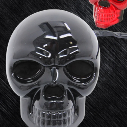 Close up of glossy black skull LED trailer hitch cover showing detailed face design and red illuminated example