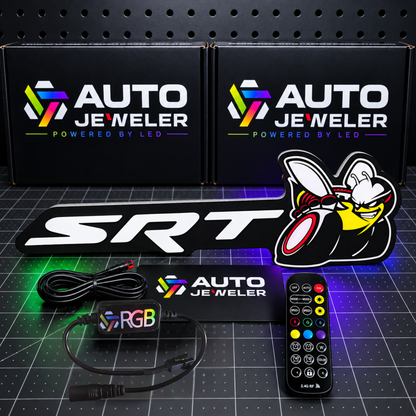 SRT Bee Flow Series RGB LED emblem shown unlit with AutoJeweler packaging, RGB controller, remote and wiring