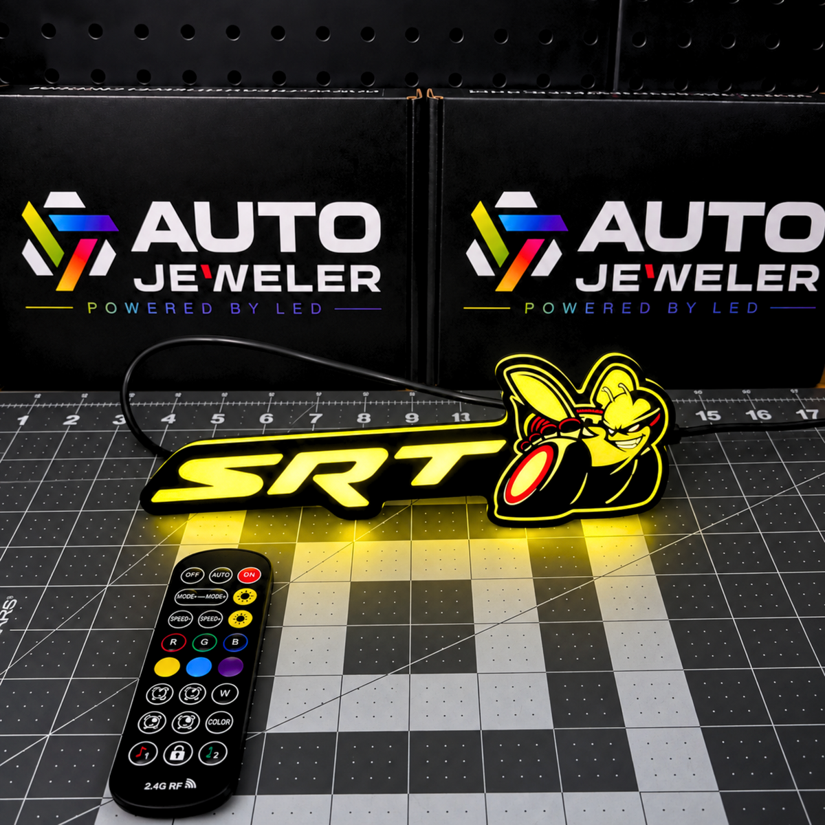 SRT Bee Flow Series RGB LED emblem illuminated yellow with handheld RF remote