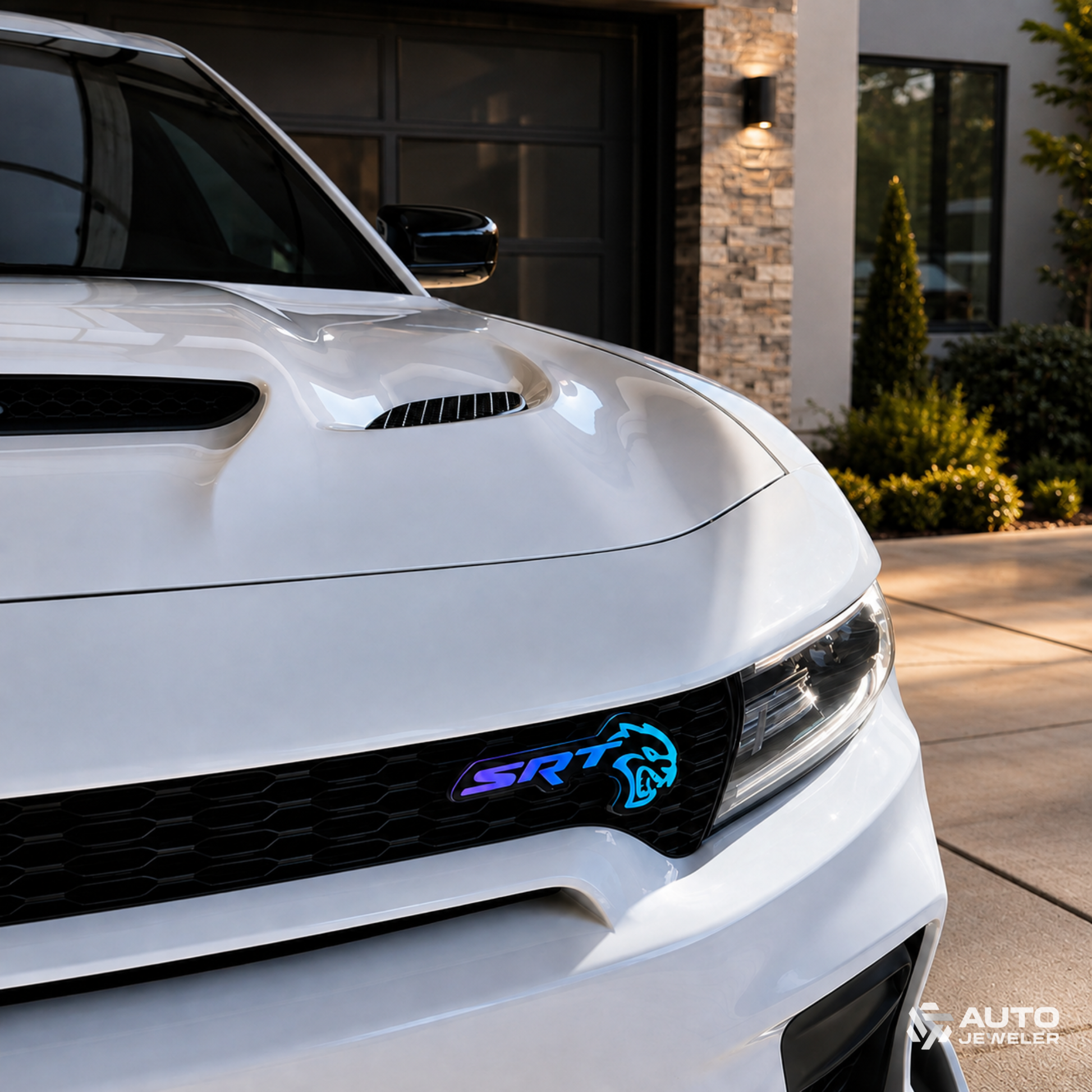 SRT Hellcat RGB Flow Series LED emblem installed on the front grille of a white Dodge vehicle