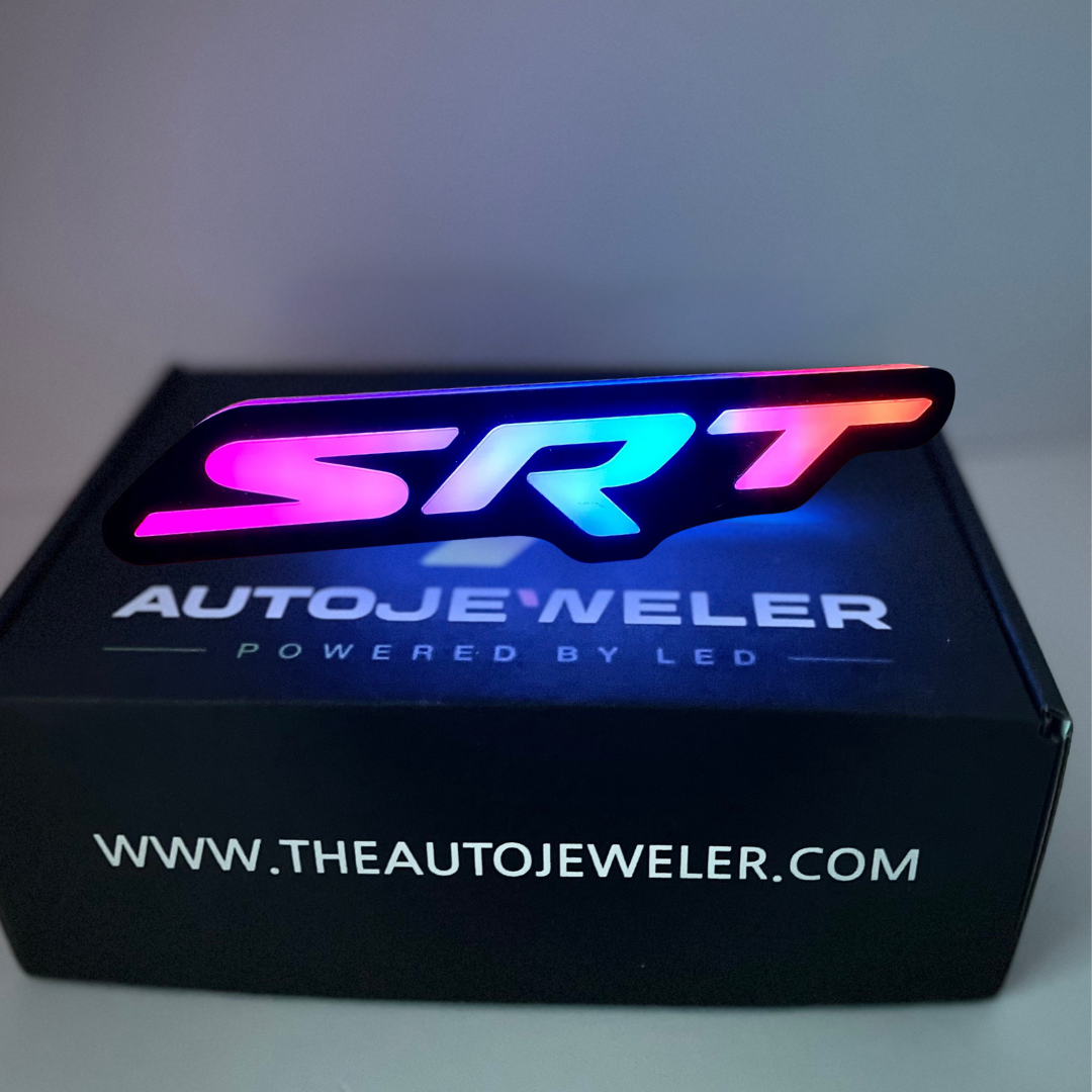 SRT illuminated LED grille emblem displayed on AutoJeweler branded box.
