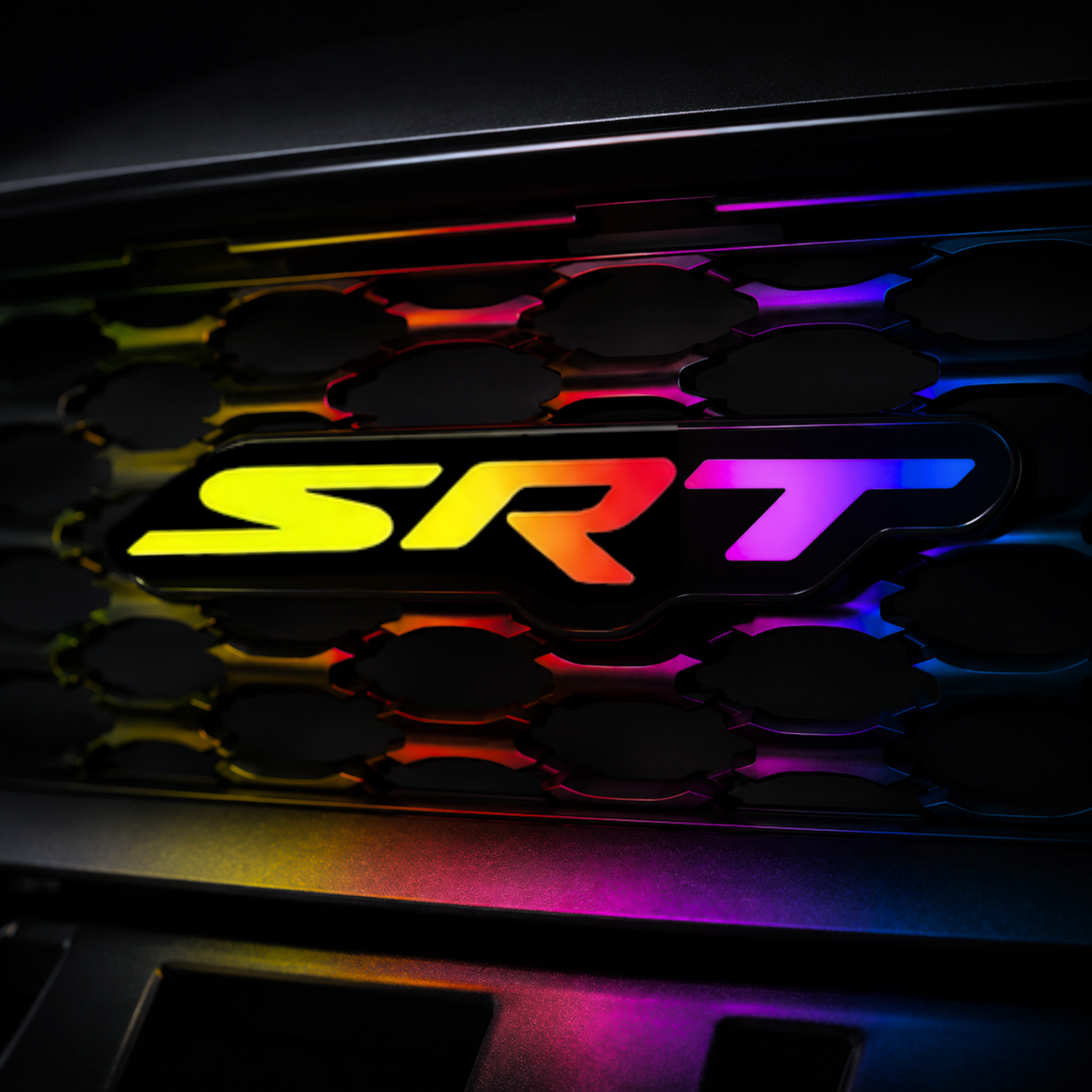 SRT RGB Flow Series LED grille emblem installed on black grille with rainbow flow lighting and realistic color reflections.