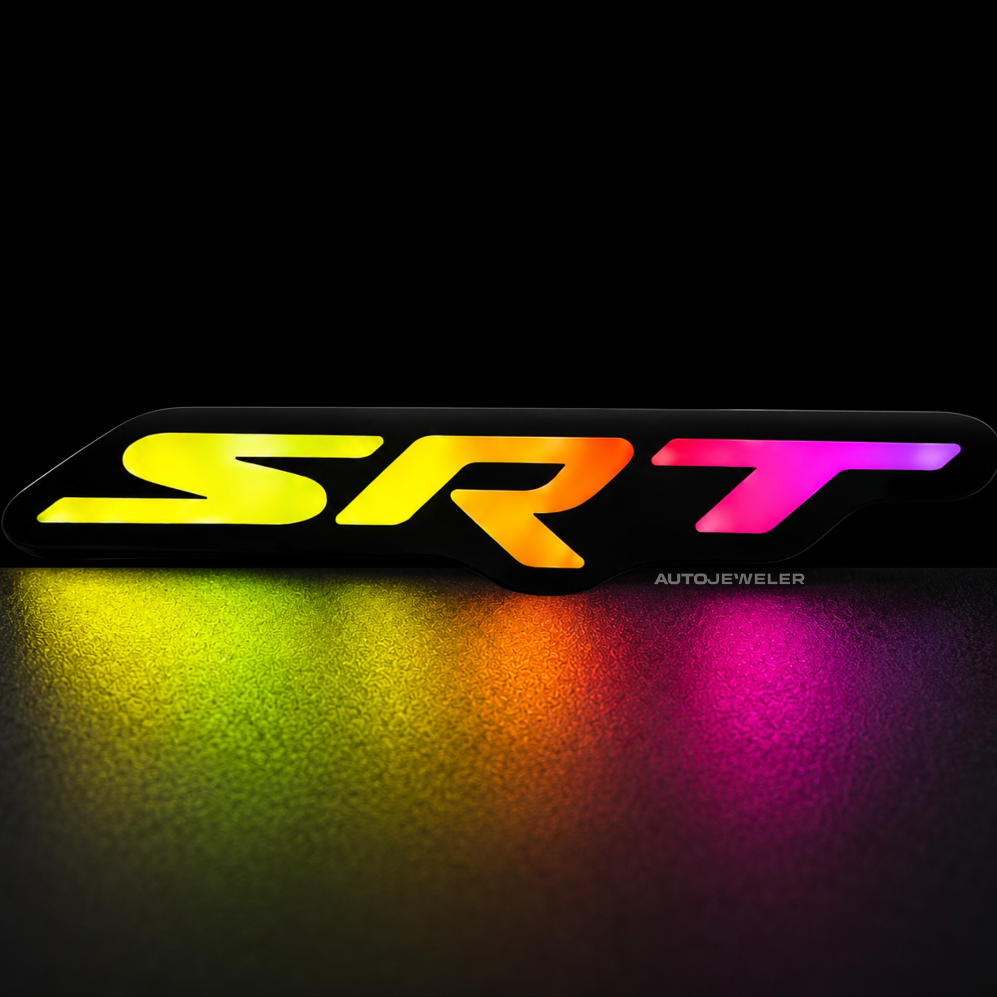 SRT RGB Flow Series LED emblem glowing in rainbow mode on dark studio background with colorful reflection