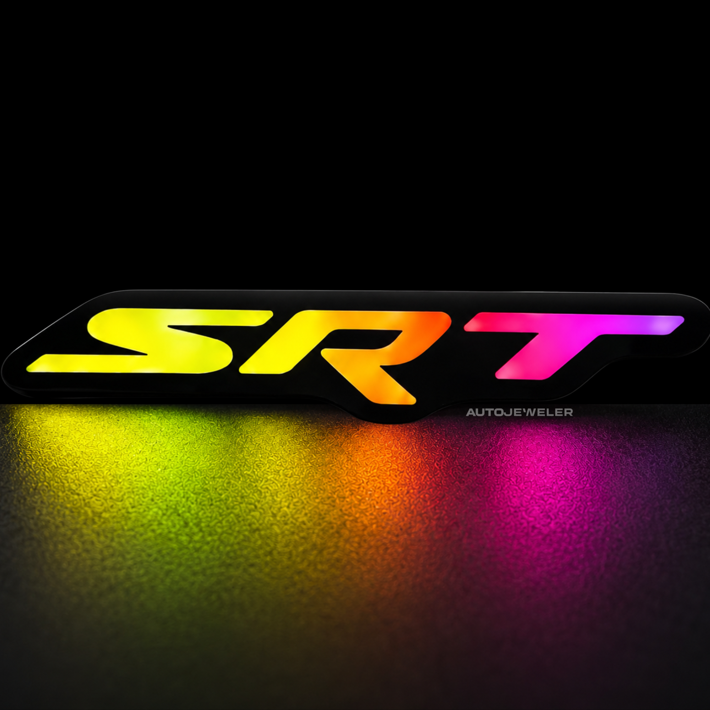 SRT RGB Flow Series LED emblem glowing in rainbow mode on dark studio background with colorful reflection