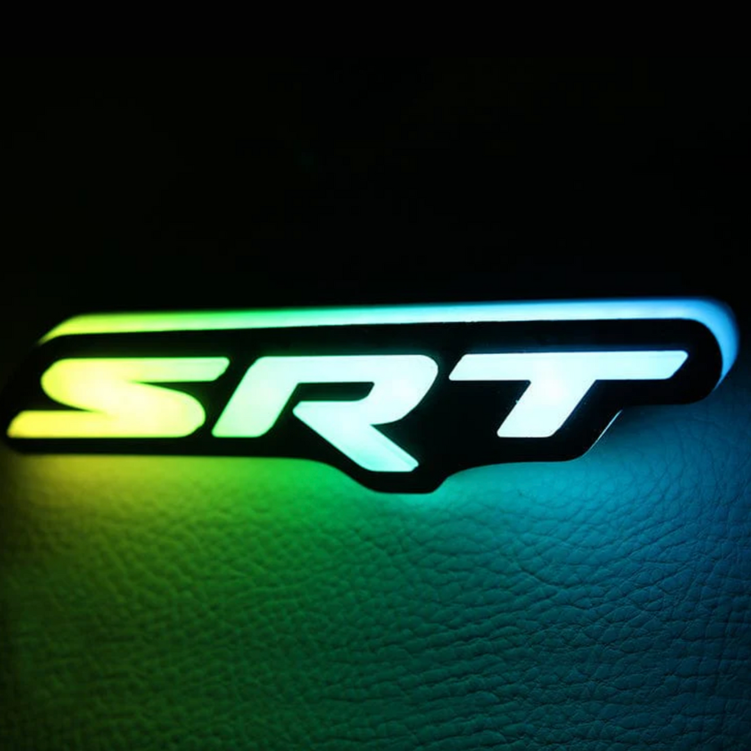 SRT grille emblem glowing with RGB Flow-Series green and yellow LED lighting.