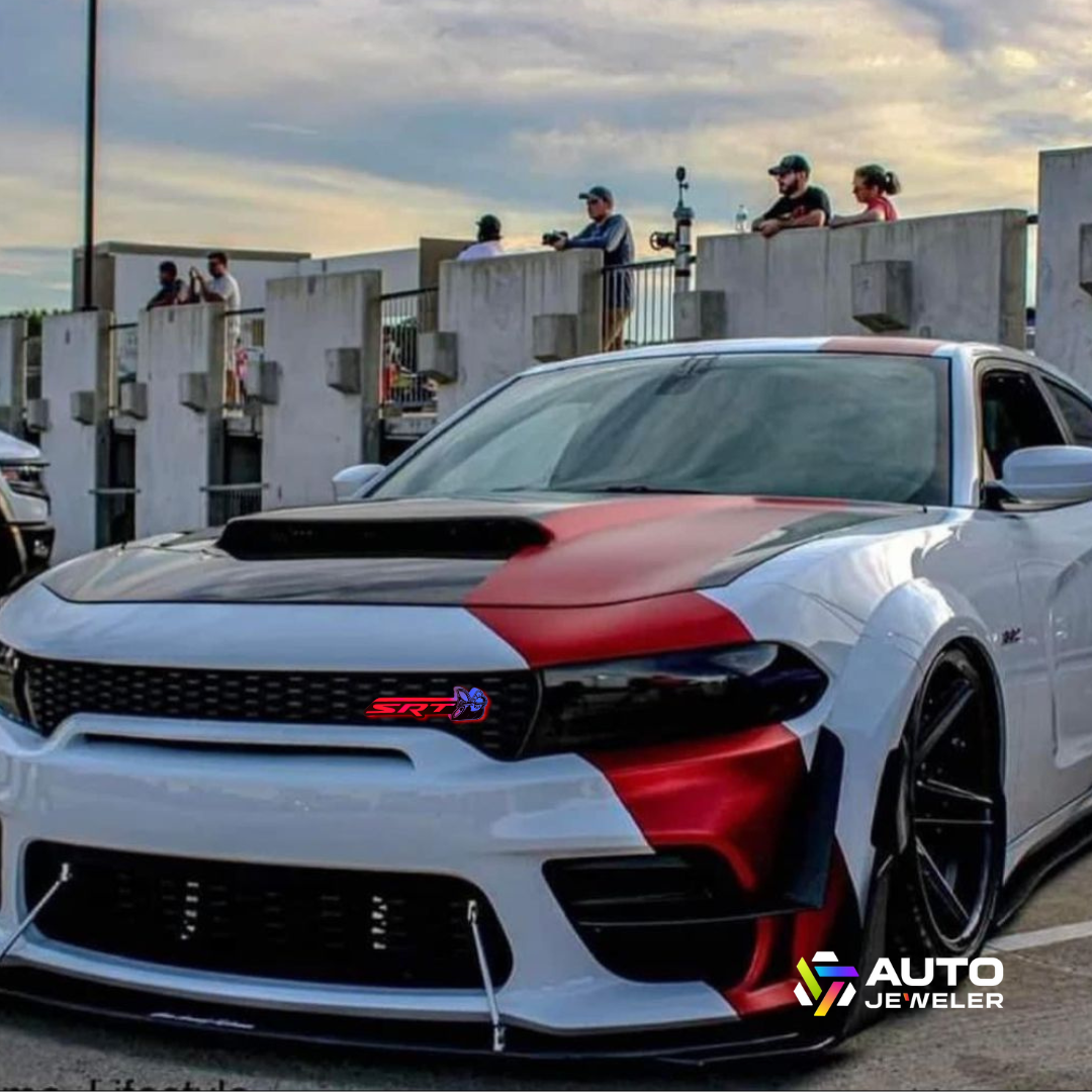 Dodge Charger with SRT Scat Bee RGB emblem glowing red and blue on front grille.