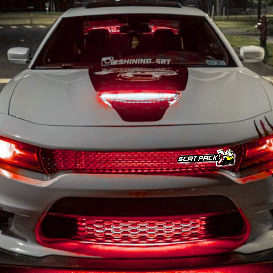 Front view of a white Dodge car with red accents and 'Scat Pack' branding.